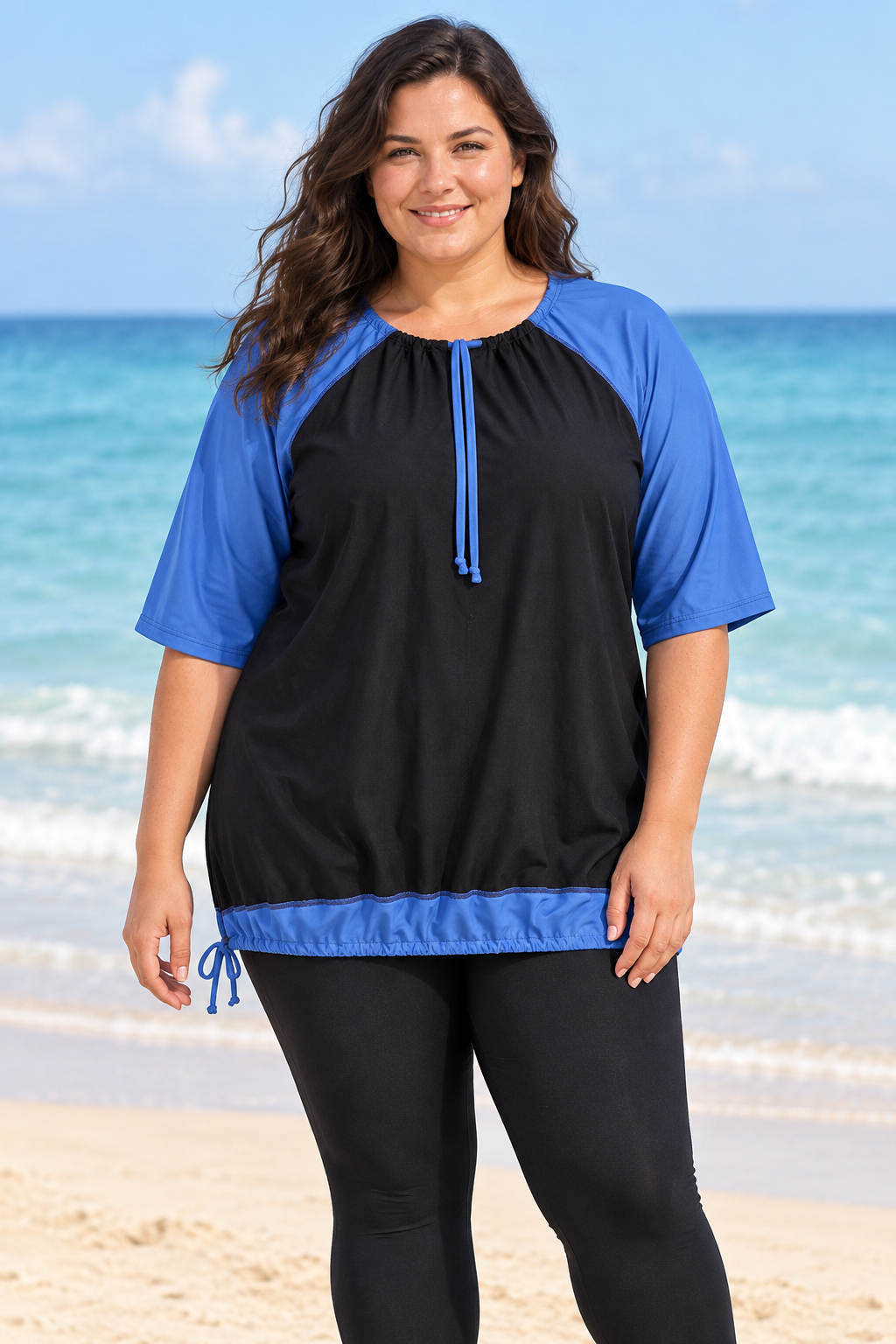Fuller-figured female model wearing the blue-and-black swim top at the beach