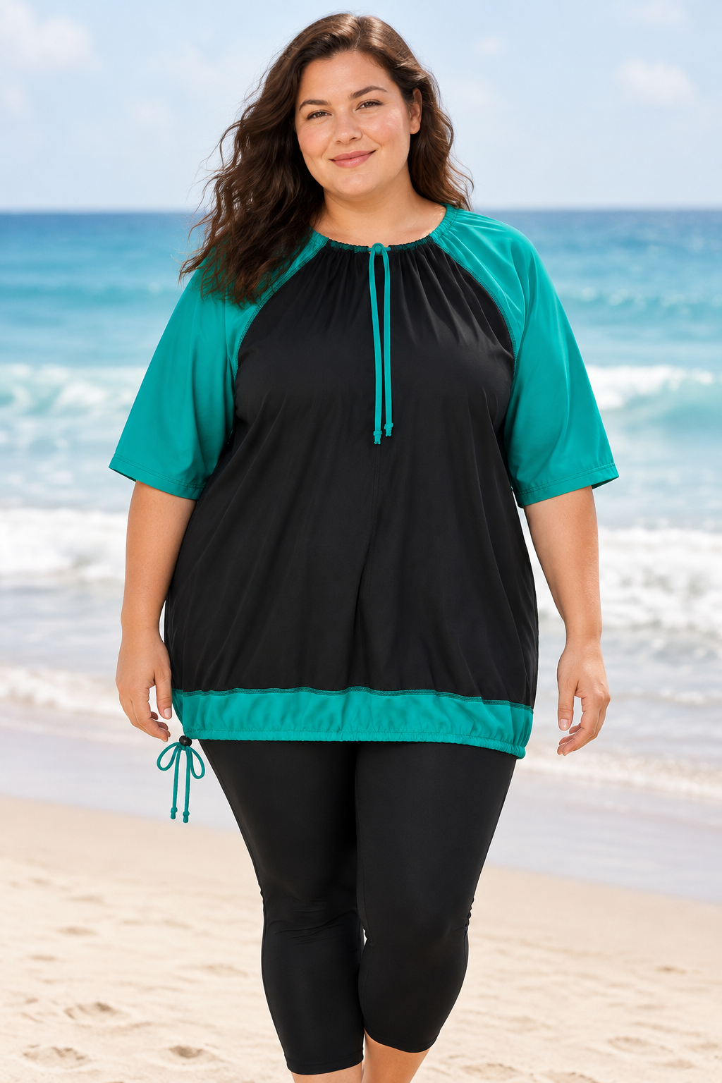 Fuller-figured female model wearing the teal-and-black swim top at the beach
